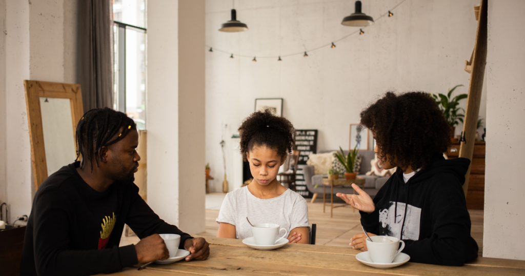 parents guiding child as she listens quietly